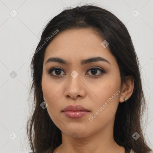 Joyful latino young-adult female with long  brown hair and brown eyes