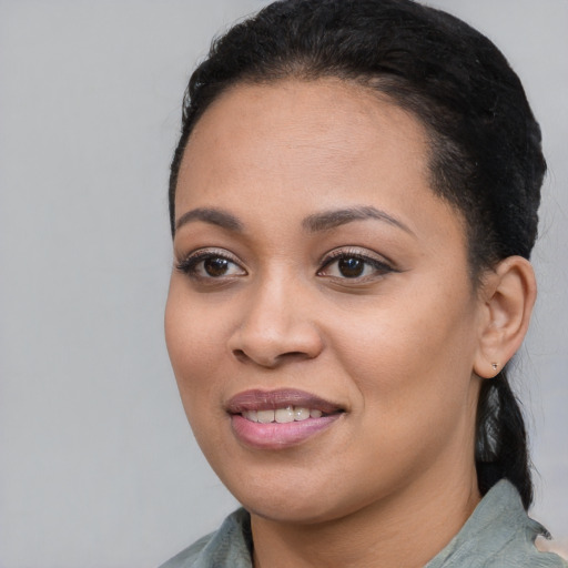 Joyful black young-adult female with medium  black hair and brown eyes