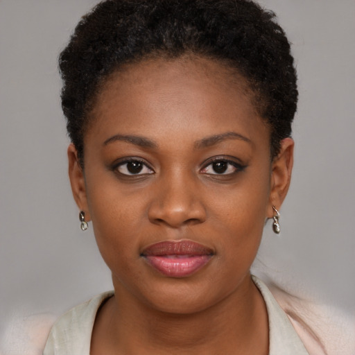 Joyful black young-adult female with short  brown hair and brown eyes