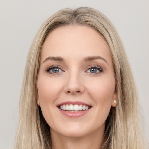 Joyful white young-adult female with long  brown hair and blue eyes