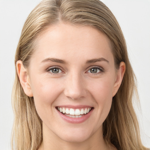 Joyful white young-adult female with long  brown hair and blue eyes