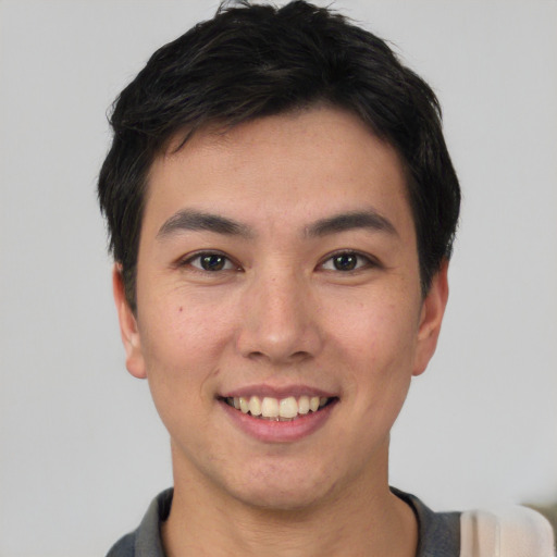 Joyful asian young-adult male with short  black hair and brown eyes