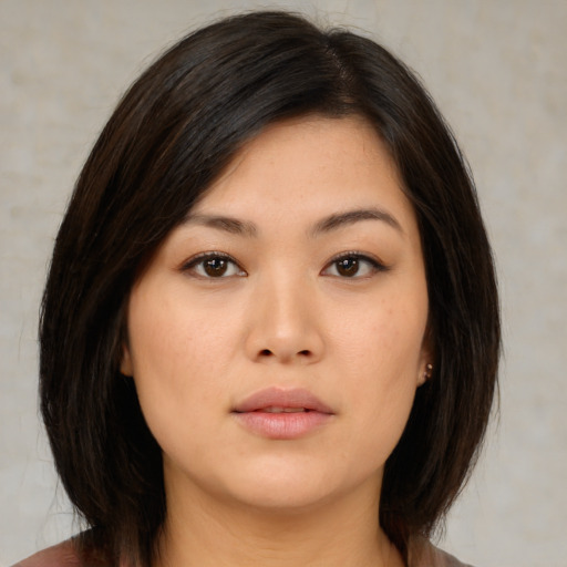 Neutral asian young-adult female with medium  brown hair and brown eyes