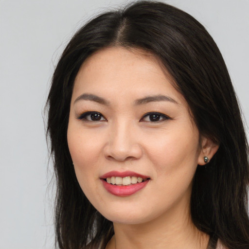 Joyful asian young-adult female with long  brown hair and brown eyes