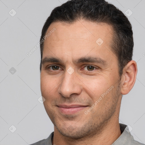 Joyful white adult male with short  brown hair and brown eyes