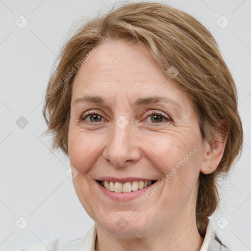 Joyful white adult female with medium  brown hair and grey eyes