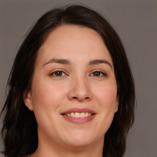 Joyful white young-adult female with medium  brown hair and brown eyes