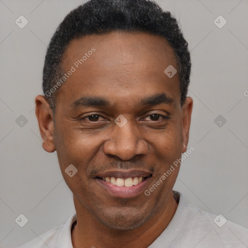 Joyful black adult male with short  black hair and brown eyes