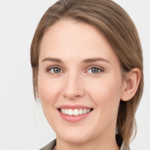 Joyful white young-adult female with medium  brown hair and grey eyes