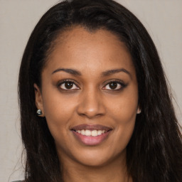 Joyful latino young-adult female with long  brown hair and brown eyes