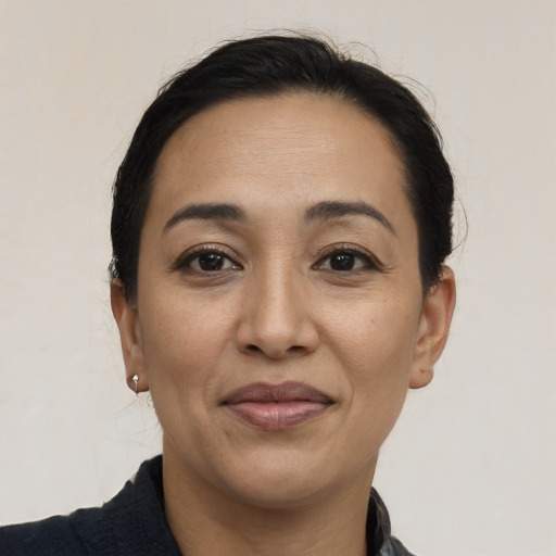 Joyful latino adult female with short  brown hair and brown eyes