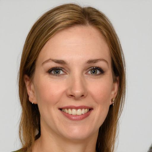 Joyful white young-adult female with long  brown hair and grey eyes