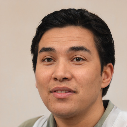 Joyful asian adult male with short  black hair and brown eyes