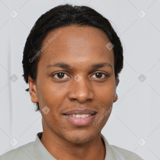 Joyful black young-adult male with short  brown hair and brown eyes