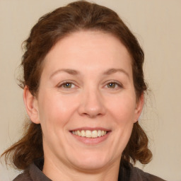 Joyful white adult female with medium  brown hair and brown eyes