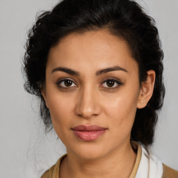 Joyful latino young-adult female with medium  brown hair and brown eyes