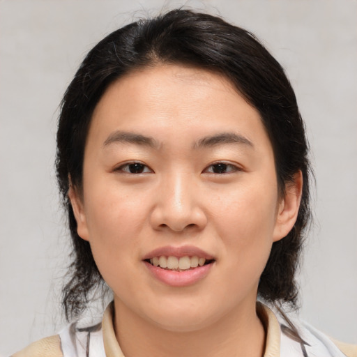 Joyful asian young-adult female with medium  brown hair and brown eyes