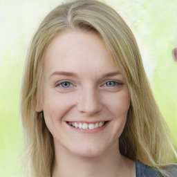 Joyful white young-adult female with long  brown hair and blue eyes