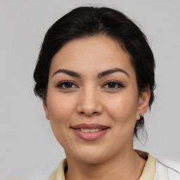 Joyful latino young-adult female with medium  brown hair and brown eyes