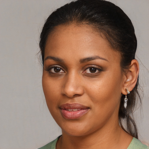 Joyful black young-adult female with medium  brown hair and brown eyes