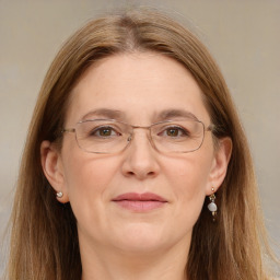 Joyful white adult female with long  brown hair and brown eyes