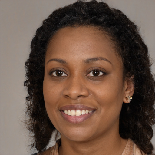 Joyful black young-adult female with medium  brown hair and brown eyes