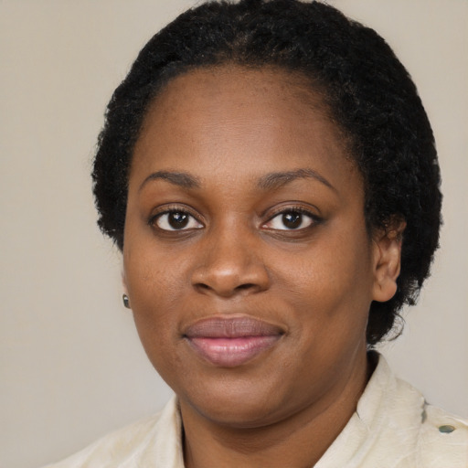 Joyful black young-adult female with medium  brown hair and brown eyes