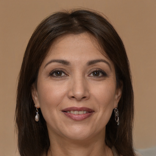 Joyful white adult female with long  brown hair and brown eyes