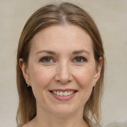 Joyful white adult female with medium  brown hair and grey eyes