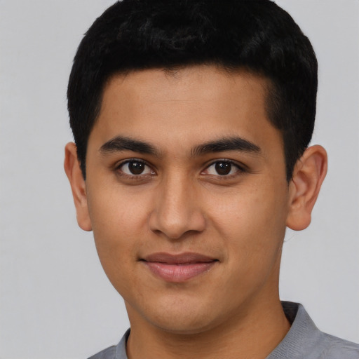 Joyful latino young-adult male with short  black hair and brown eyes