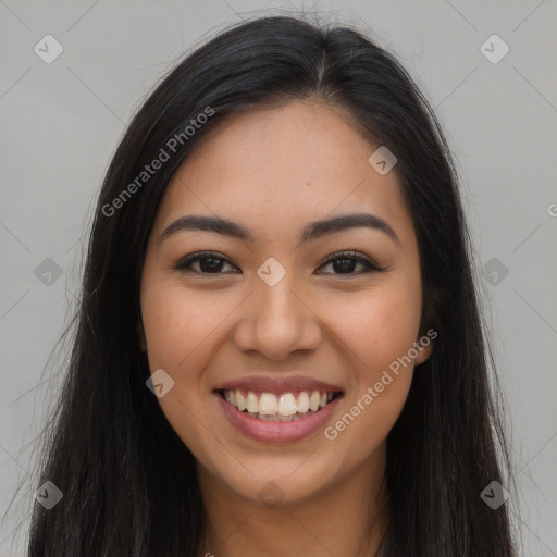 Joyful latino young-adult female with long  brown hair and brown eyes