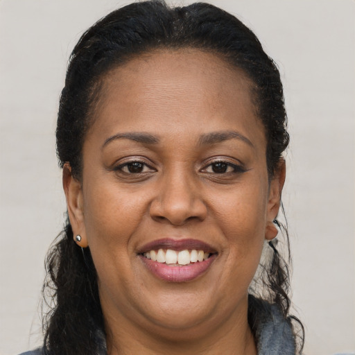 Joyful latino adult female with long  brown hair and brown eyes