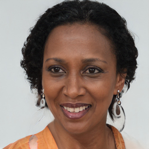 Joyful black adult female with long  brown hair and brown eyes