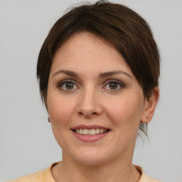 Joyful white adult female with medium  brown hair and brown eyes