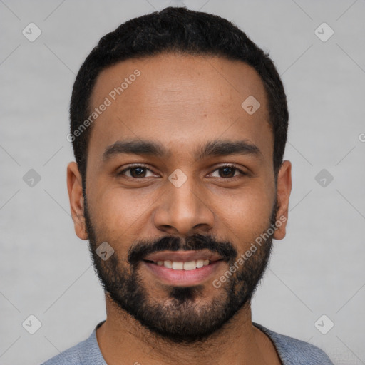 Joyful black young-adult male with short  black hair and brown eyes