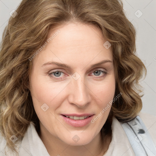 Joyful white adult female with medium  brown hair and blue eyes