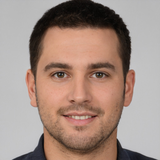 Joyful white young-adult male with short  brown hair and brown eyes