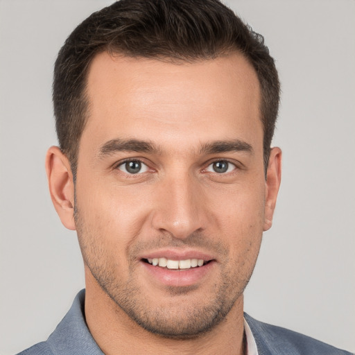 Joyful white young-adult male with short  brown hair and brown eyes