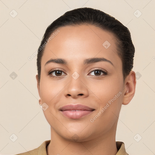 Joyful latino young-adult female with short  black hair and brown eyes