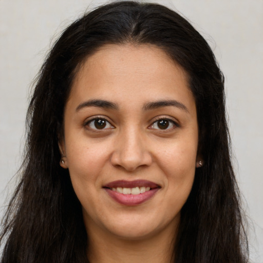 Joyful white young-adult female with long  brown hair and brown eyes