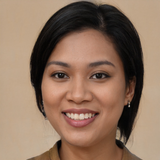 Joyful latino young-adult female with long  black hair and brown eyes