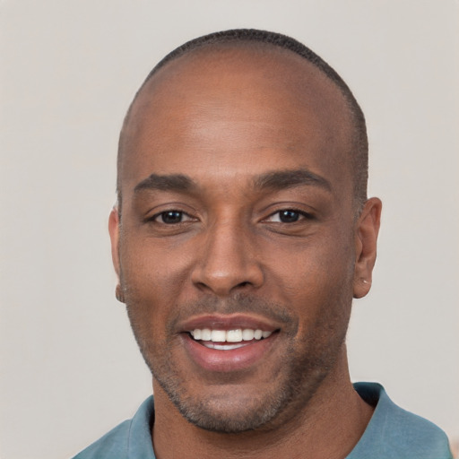 Joyful black young-adult male with short  brown hair and brown eyes