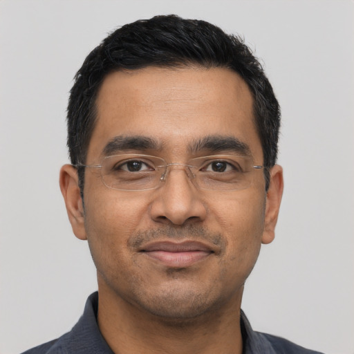 Joyful latino adult male with short  black hair and brown eyes