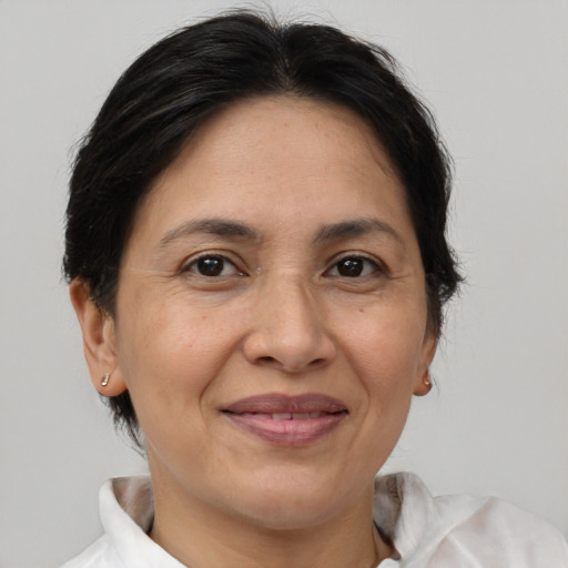 Joyful white adult female with medium  brown hair and brown eyes