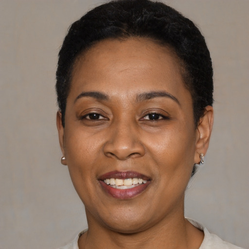 Joyful latino adult female with short  black hair and brown eyes