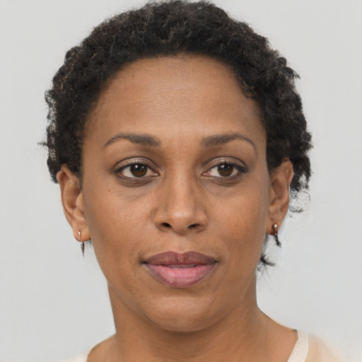 Joyful black adult female with short  brown hair and brown eyes