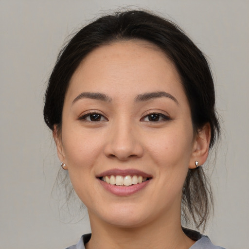 Joyful asian young-adult female with medium  brown hair and brown eyes