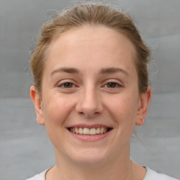 Joyful white young-adult female with short  brown hair and grey eyes