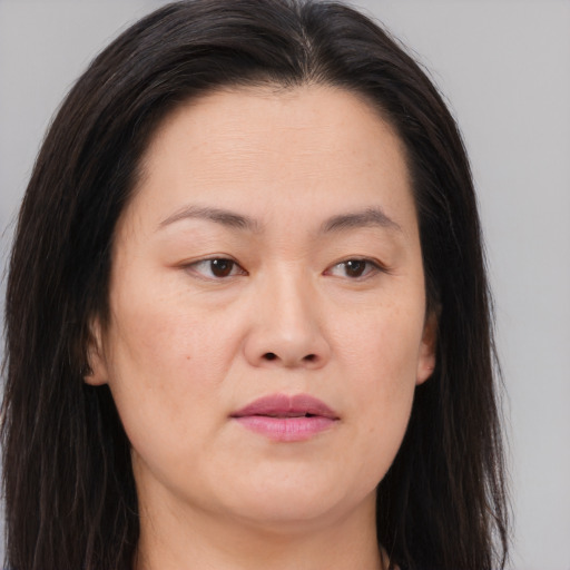 Joyful asian young-adult female with long  brown hair and brown eyes
