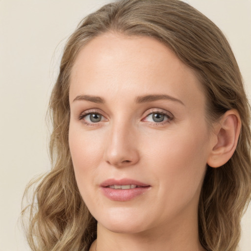 Joyful white young-adult female with long  brown hair and green eyes